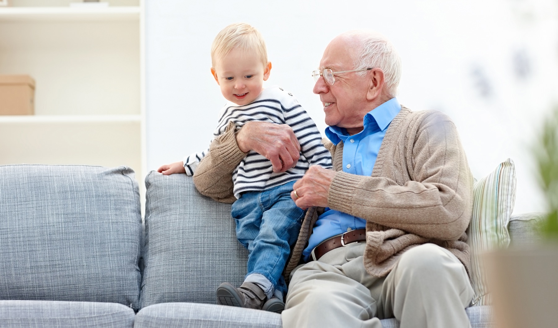 Grandfather playing with his grandson in the living room 